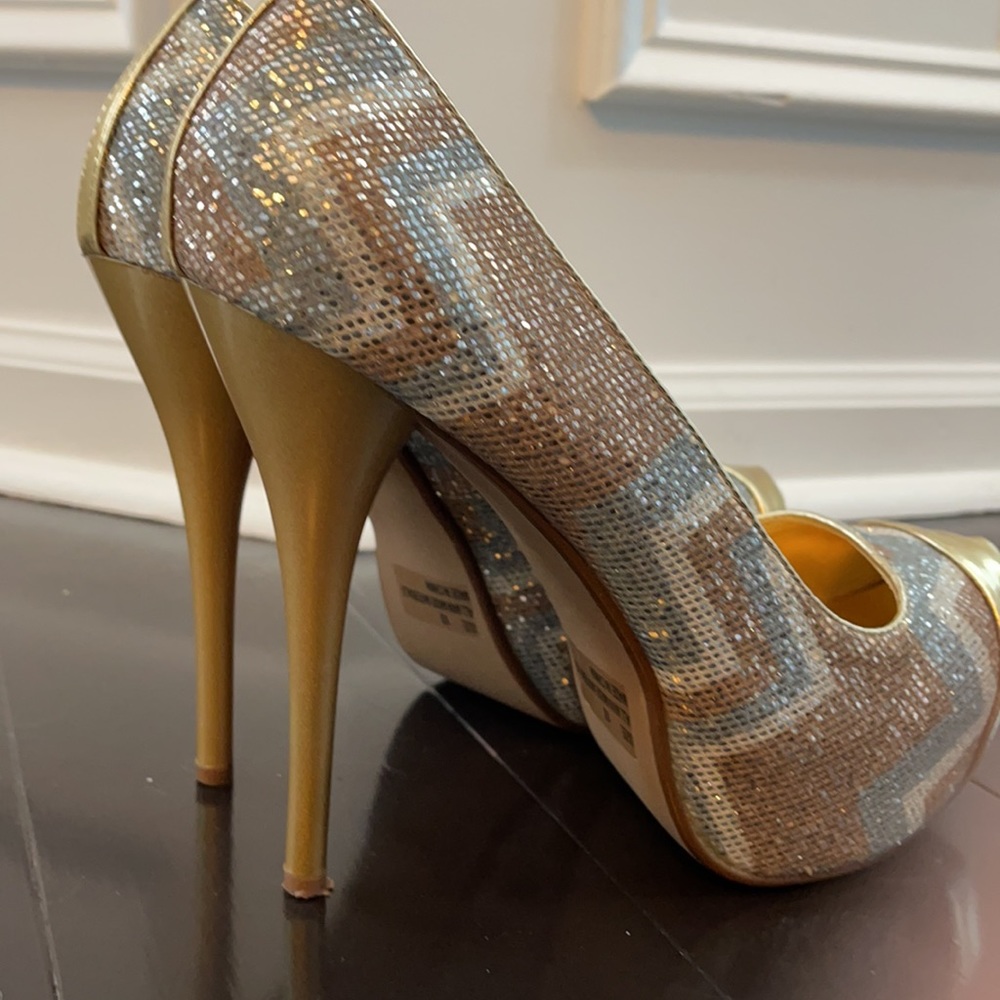 Slightly worn multi colored heels. Gold toe tip.